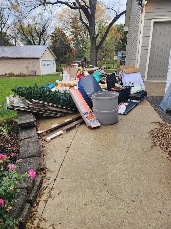 Dumpster being loaded with debris for 12 Yard Dumpster Rental in Derby